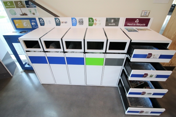 A designated waste, recycling, and composting stations in the building.