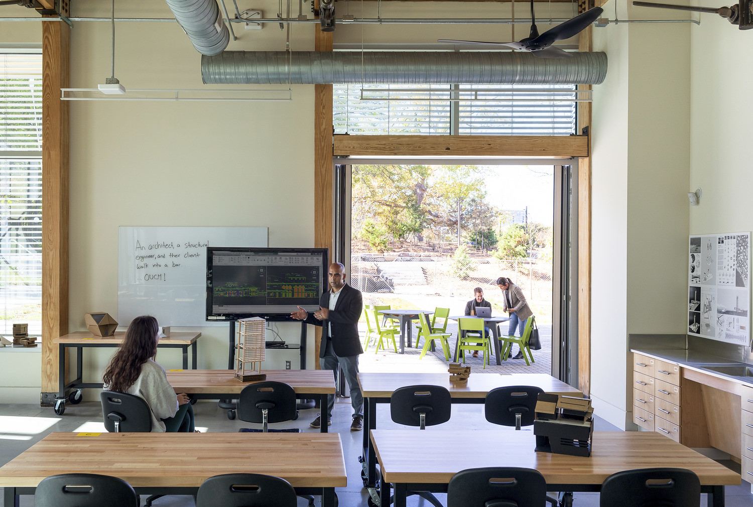 Teacher and student enjoying the open windows in a Kendeda space