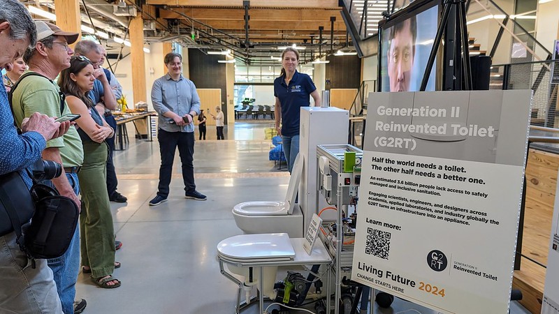 Image of the Regenerative Toilet and information as a tour group views it