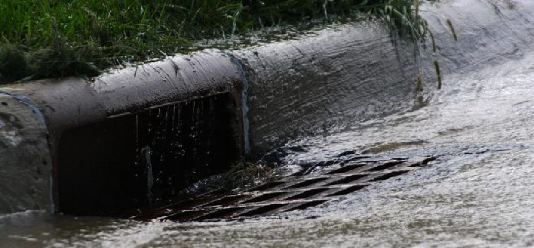 image of water flowing over a strom drain