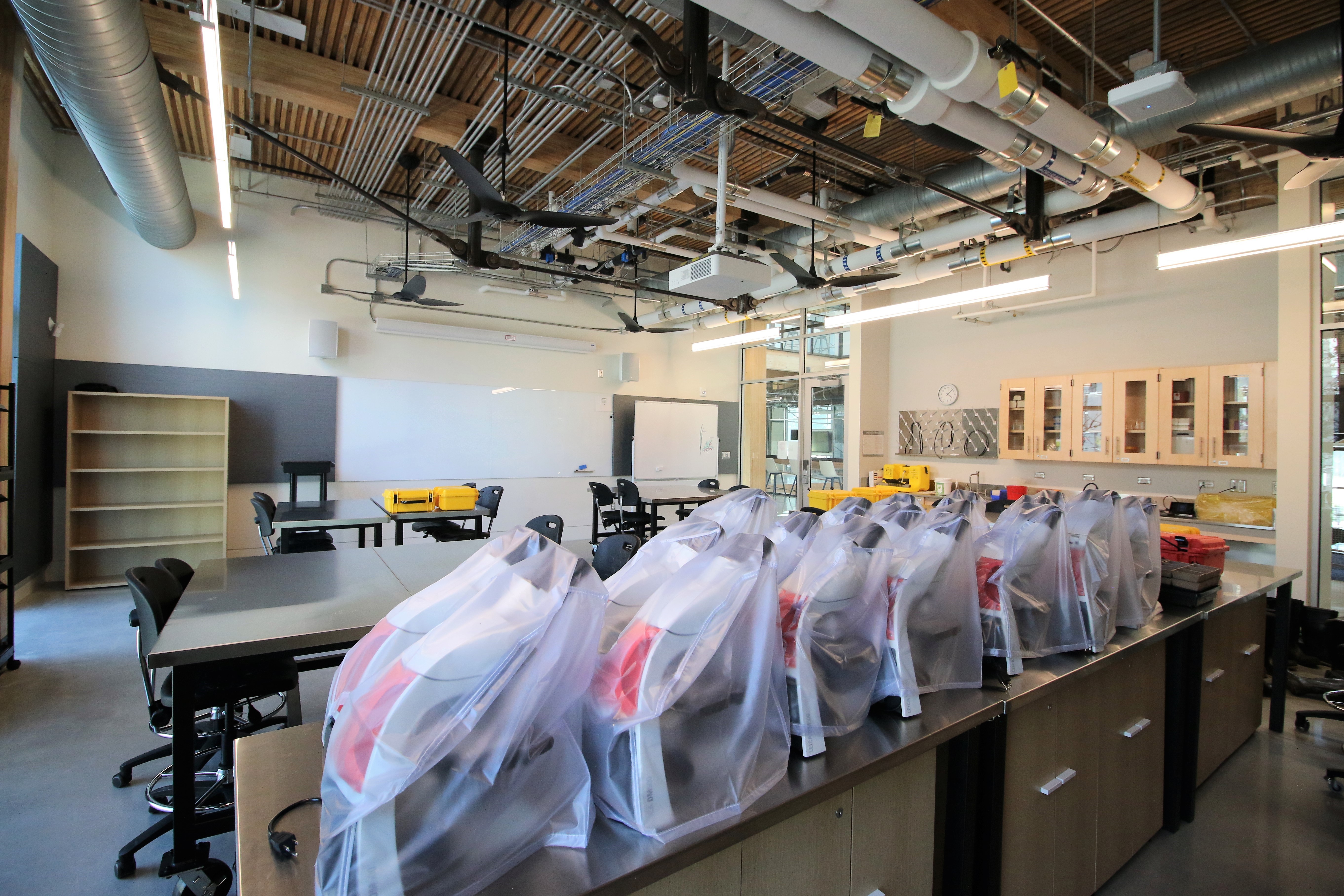 Microscopes and other equipment used for a biology class lab.