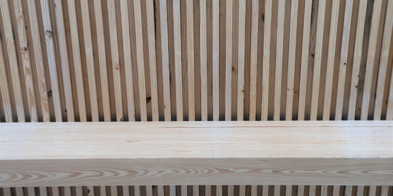 Salvaged 2x4 pieces of wood were incorporated into the building's floor/ceiling assembly.