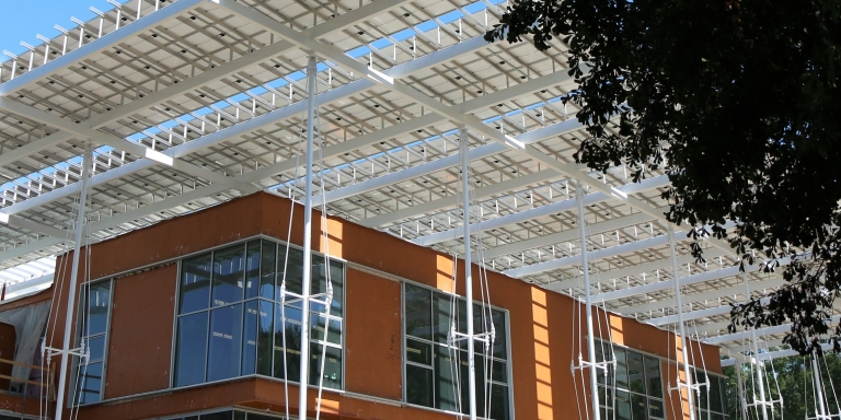The orange layer seen in this image is a fluid-applied air-and-water barrier made by a company that specifically removed red-list materials from its product in order to comply with the Living Building Challenge.