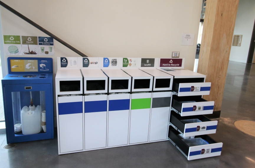 The coffee recycling station alongside one of the indoor materials management stations. The drawers can be extended to place designated hard-to-recycle products.